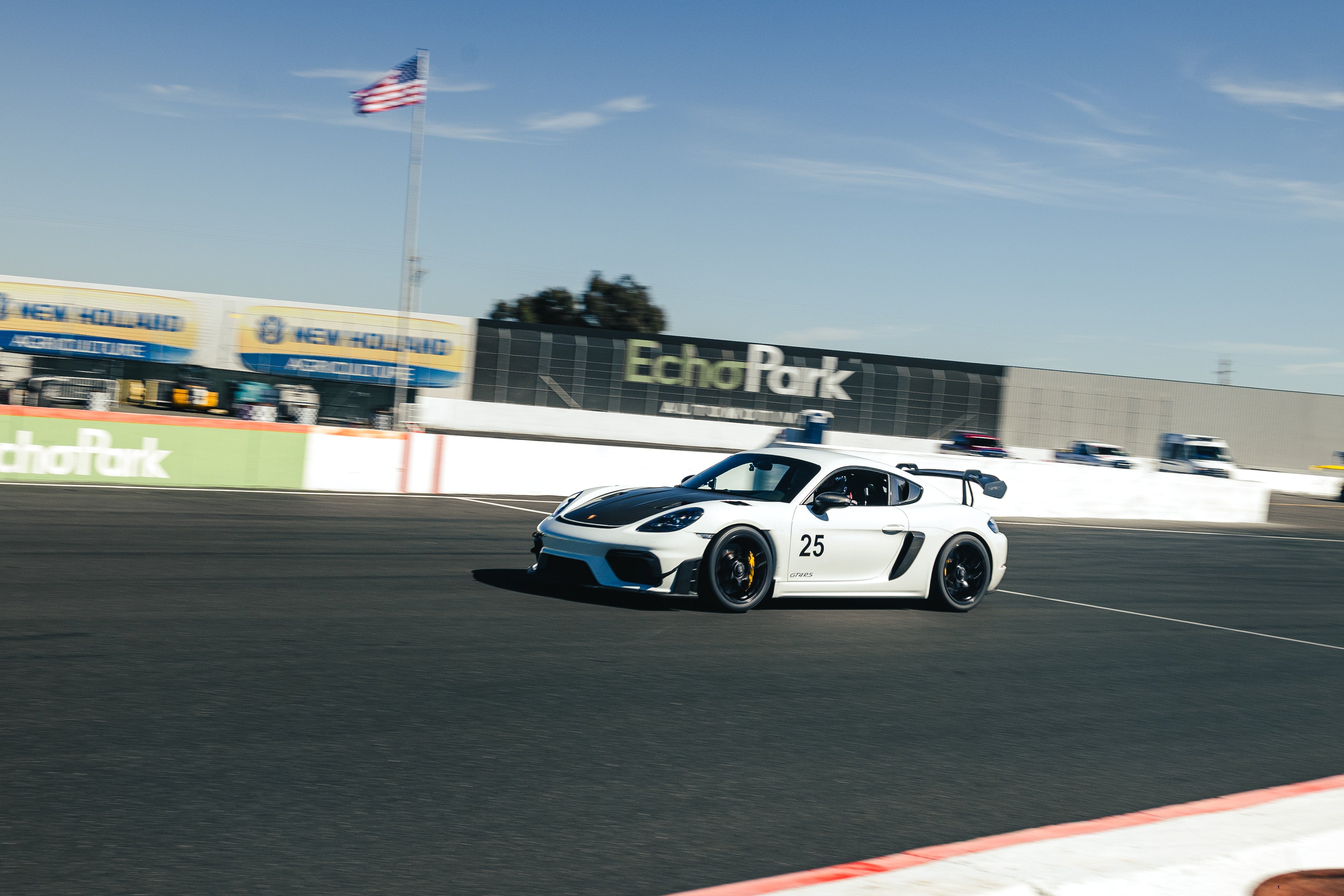 White race car with number 25 on a track, featuring 'Echo Park' branding in the background.